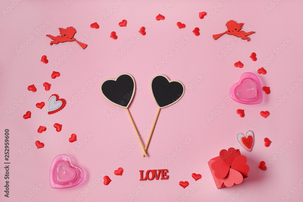 Valentine's Day. Frame made of gifts, heart confetti, angels on pink background. Valentines day background.