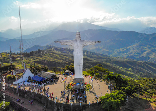 Cristo Rey Statue with city view photo