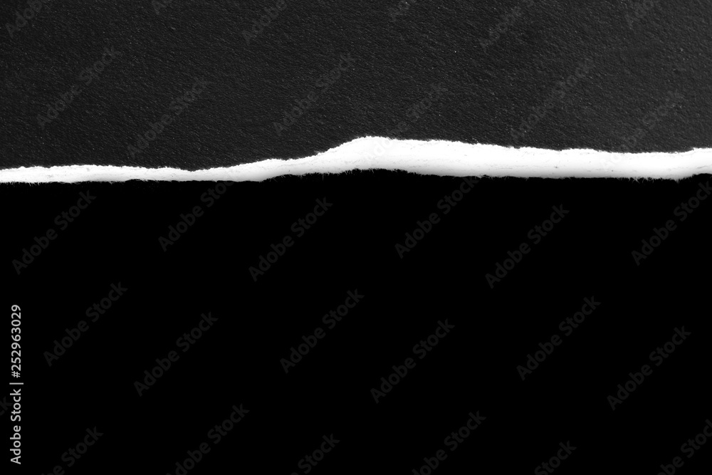 Piece of torn paper on black. Copy space Piece of torn paper on black. Copy space