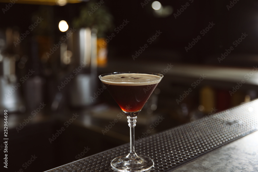 Glass of martini espresso cocktail on bar counter, closeup. Space for text Glass of martini espresso cocktail on bar counter, closeup. Space for text