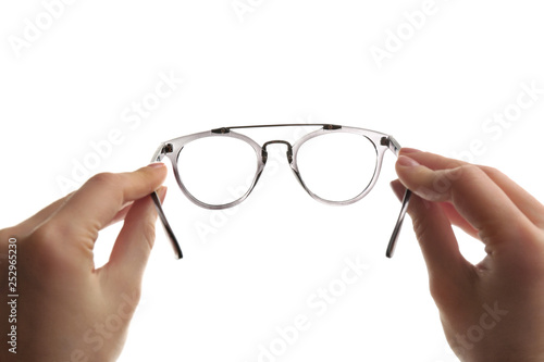 Female ophthalmologist holding glasses on white background, closeup