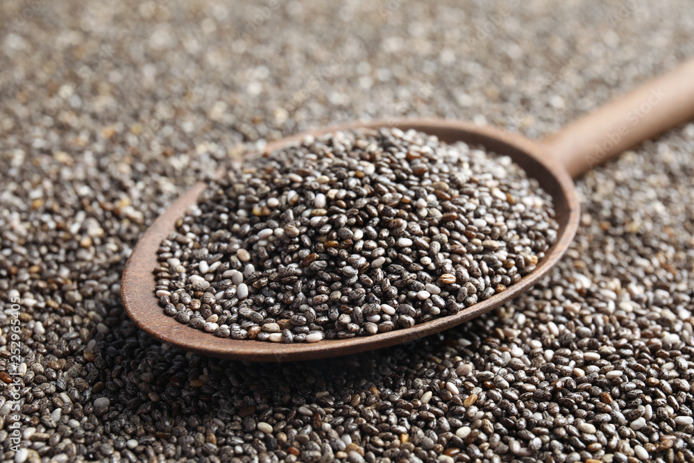 Spoon of chia seeds on grains, closeup Spoon of chia seeds on grains, closeup