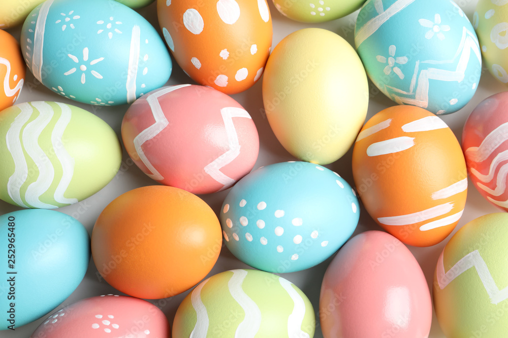 Many beautiful painted Easter eggs as background, top view