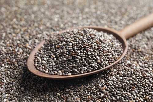 Spoon of chia seeds on grains, closeup