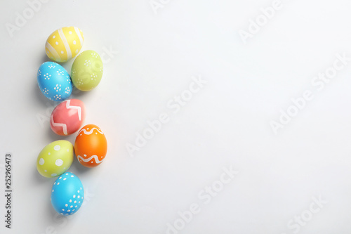 Beautiful painted Easter eggs on white background, top view