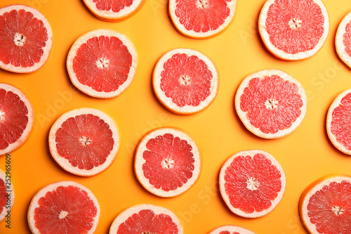 Fresh sliced ripe grapefruit on color background  flat lay