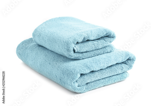 Folded clean soft towels on white background