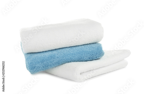 Folded clean soft towels on white background