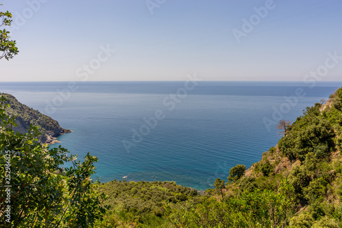 Italy, Cinque Terre, Corniglia, a close up of a hillside next to a body of water © SkandaRamana