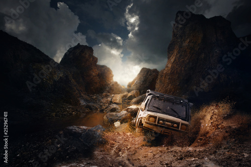 4x4 off road vehicle coming out of a mud hole hazard,mud and water splash in off-road racing on mountain road.