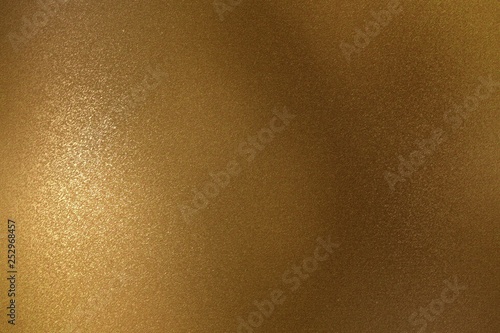 Shiny rough bronze metal wall, abstract texture background