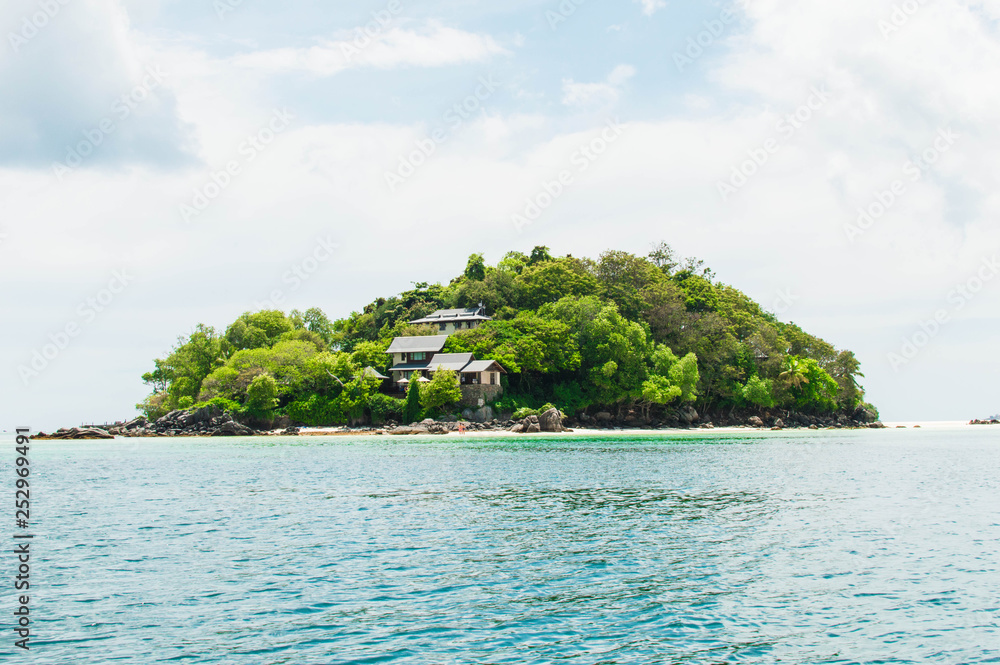 tropical green island in the middle of the blue sea tropical green island in the middle of the blue sea