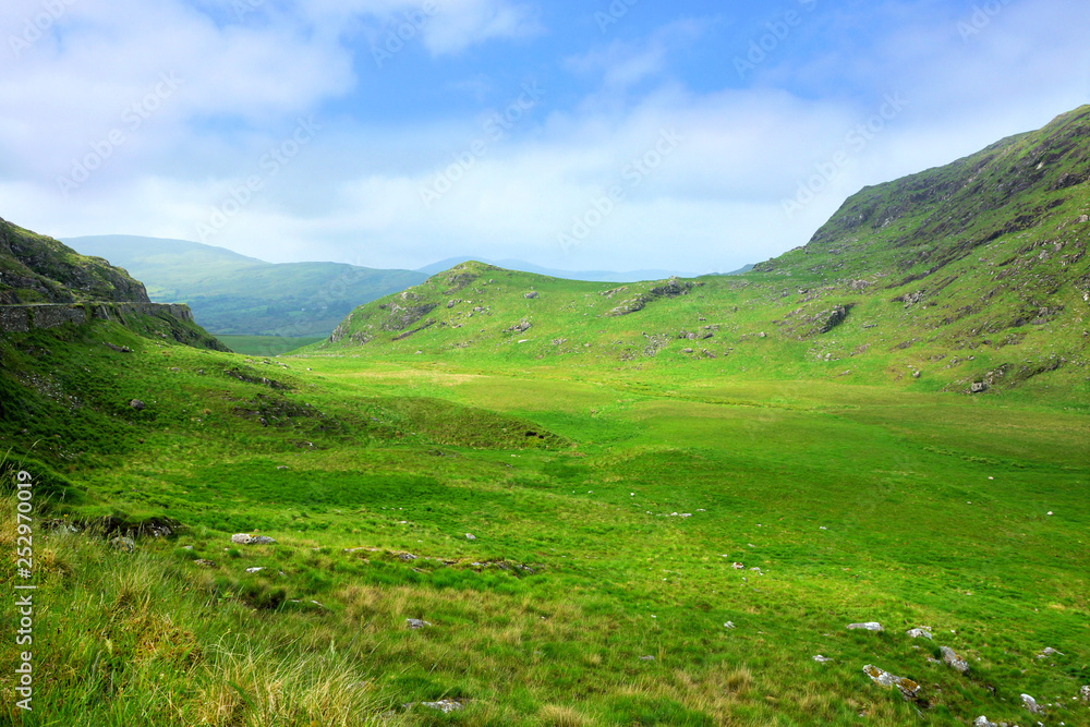 Picturesque green fields of Molls Gap mountain pass along the Ring of Kerry, Ireland Picturesque green fields of Molls Gap mountain pass along the Ring of Kerry, Ireland