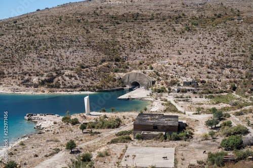 Old and abandoned submarine base with the entrance of an uboat bunker in Porto Palermo in Albania of the Enver Hoxha regime photo