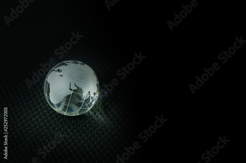 glass ball planet earth in black background.