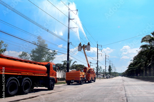 Wallpaper Mural Electricians cleaning wire and Electrical insulator with high pressure water of the power line on power pole with bucket hydraulic lifting platform or electric Picker, Hydaulic platform truck Torontodigital.ca