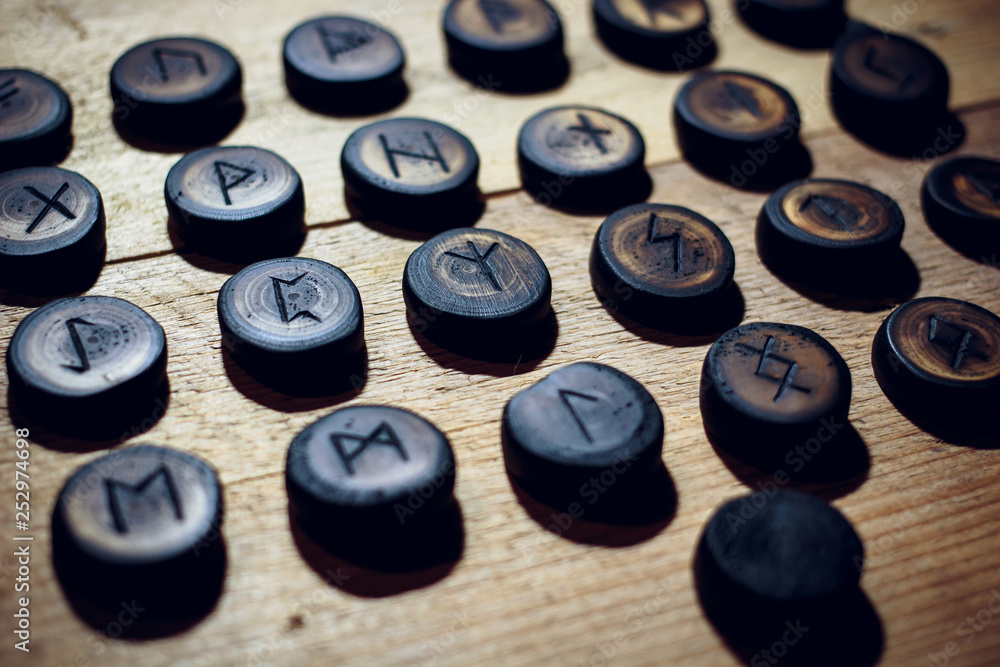 Runes carved from wood on the wood table - Elder Futhark Runes carved from wood on the wood table - Elder Futhark