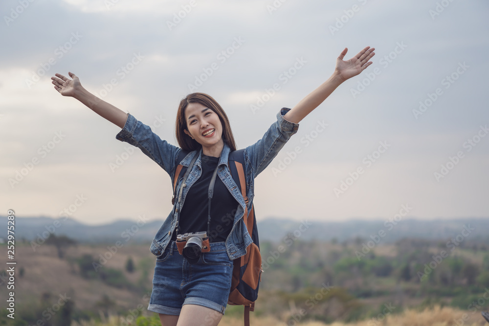 traveler woman with backpack with arms raised traveler woman with backpack with arms raised