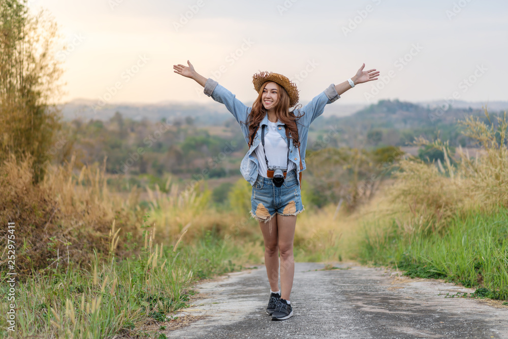 traveler woman with backpack with arms raised traveler woman with backpack with arms raised