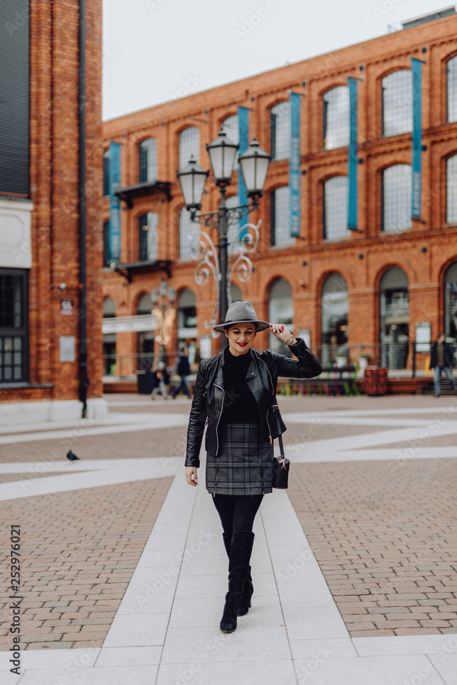 Woman walking across a city square