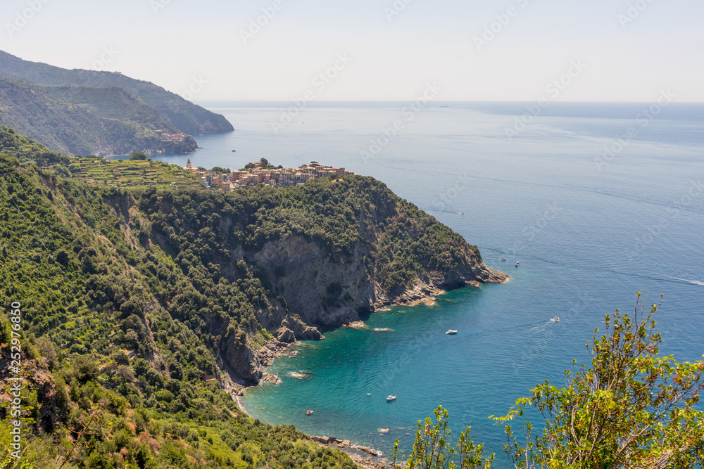 Italy, Cinque Terre, Corniglia, a body of water with a mountain in the background