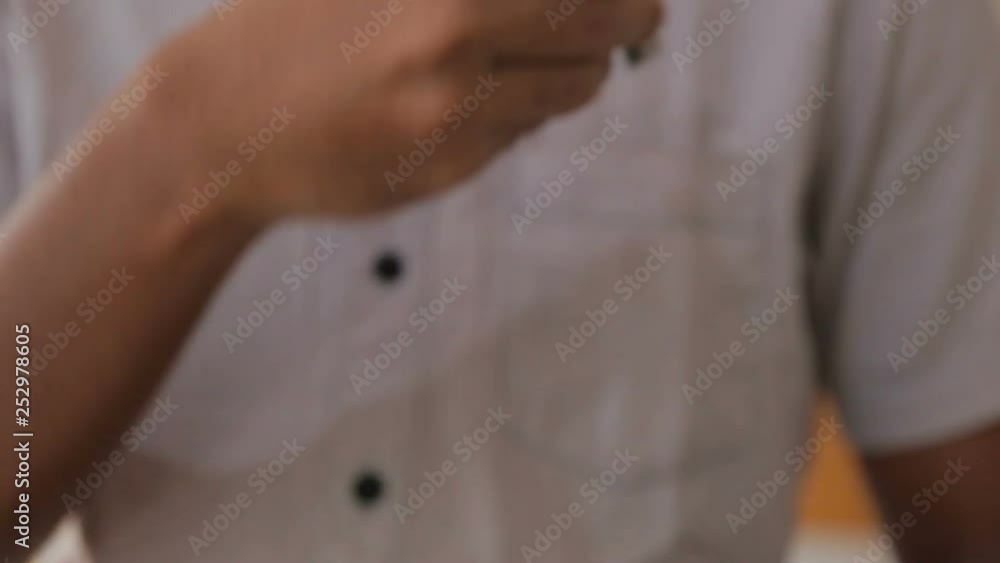 Portrait of a young man putting key in his pocket Portrait of a young man putting key in his pocket