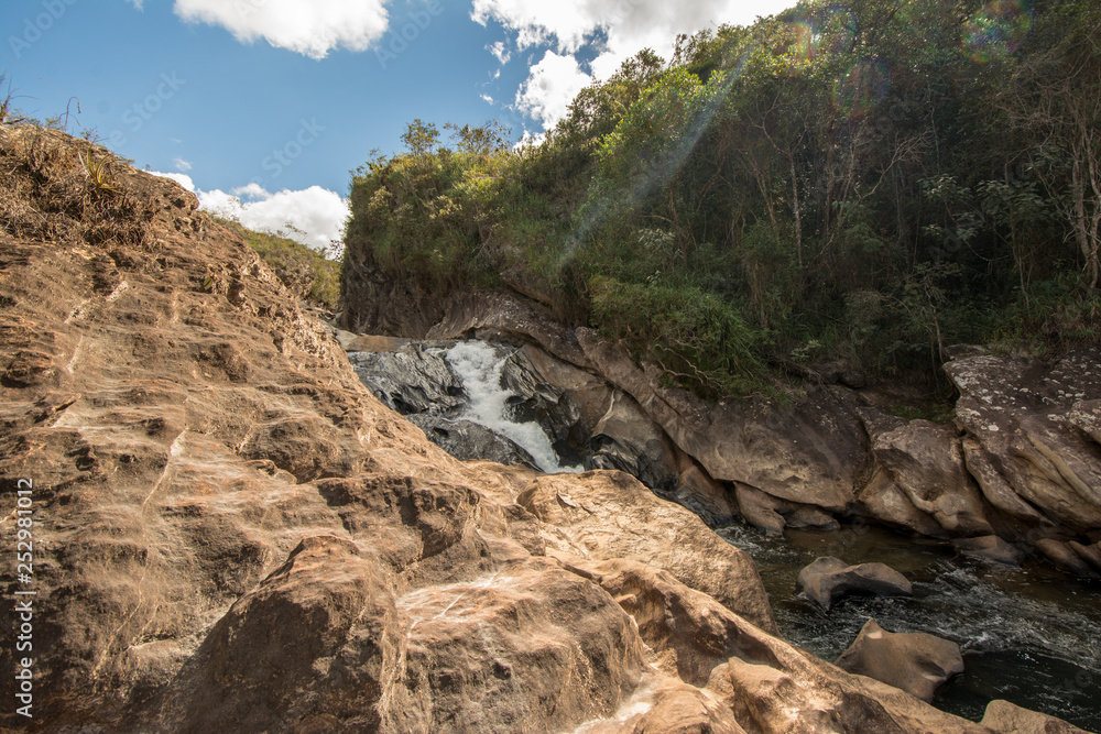 Stony creek in rural Brazil, with lush vegetation around it, on a bright sunny day. Stony creek in rural Brazil, with lush vegetation around it, on a bright sunny day.