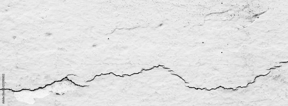 Fototapeta premium black and white, monochrome shot of cracked concrete wall texture for banner background