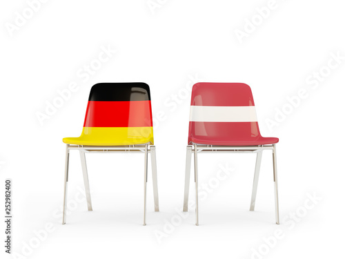 Two chairs with flags of Germany and latvia