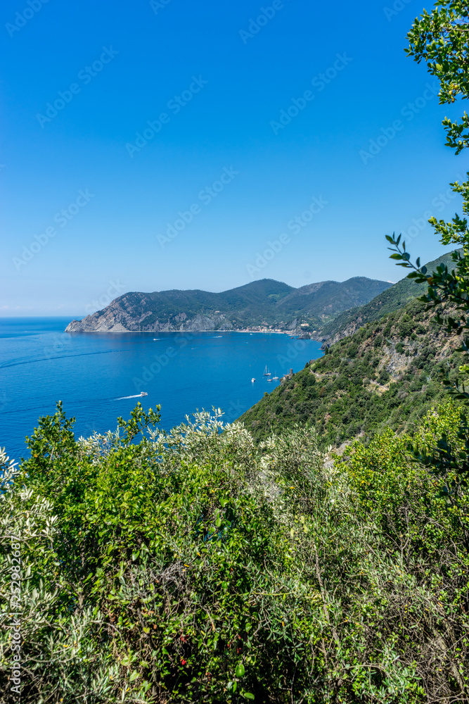 Italy, Cinque Terre, Corniglia, a body of water with a mountain in the background