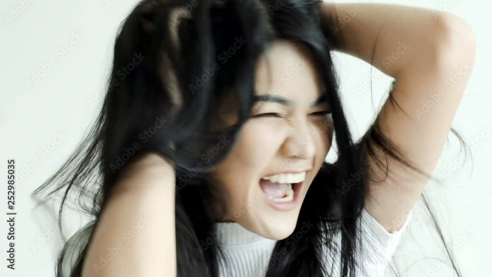 Slow motion of young beautiful asian woman spinning her head, very angry mood. Social pressure issue concept. Slow motion of young beautiful asian woman spinning her head, very angry mood. Social pressure issue concept.