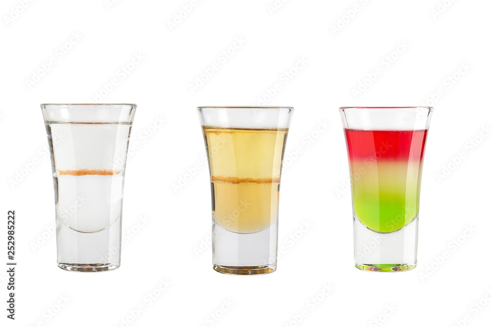 Set of alcohol shots on a white background. Three shots with different types of alcohol. Set of alcohol shots on a white background. Three shots with different types of alcohol.