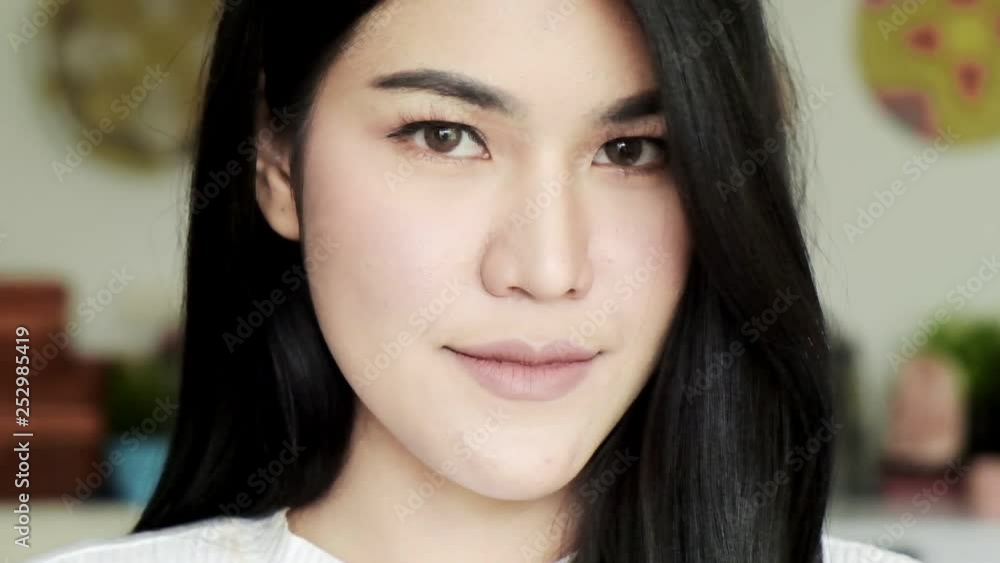 Slow motion of young beautiful asian woman looking at camera portait. Young millennial face concept. Slow motion of young beautiful asian woman looking at camera portait. Young millennial face concept.