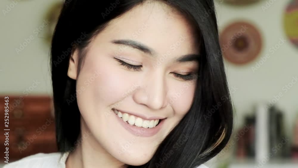 Slow motion of young beautiful asian woman happy smile at camera portait. Young millennial face concept. Slow motion of young beautiful asian woman happy smile at camera portait. Young millennial face concept.
