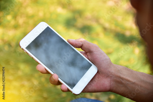 Man holding mobile smart phone using smart application by internet online