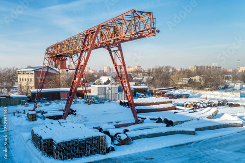 Gantry crane in open warehouse. Sunny winter day.