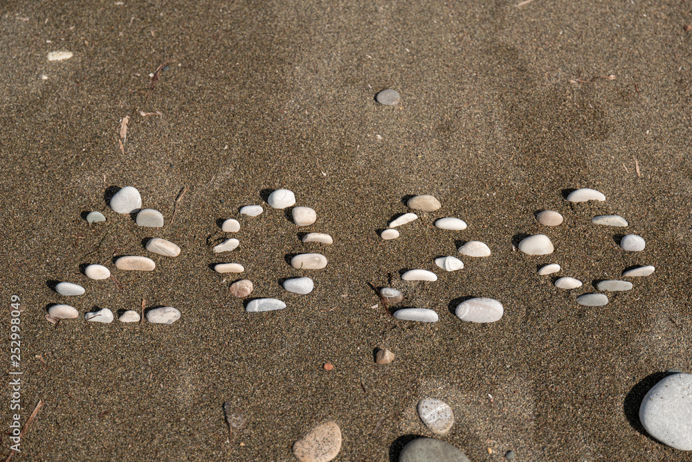 2020 Year written on the beach sand