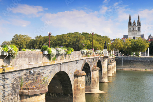 View of Angars with bridge and cathedral St Maurice France. photo