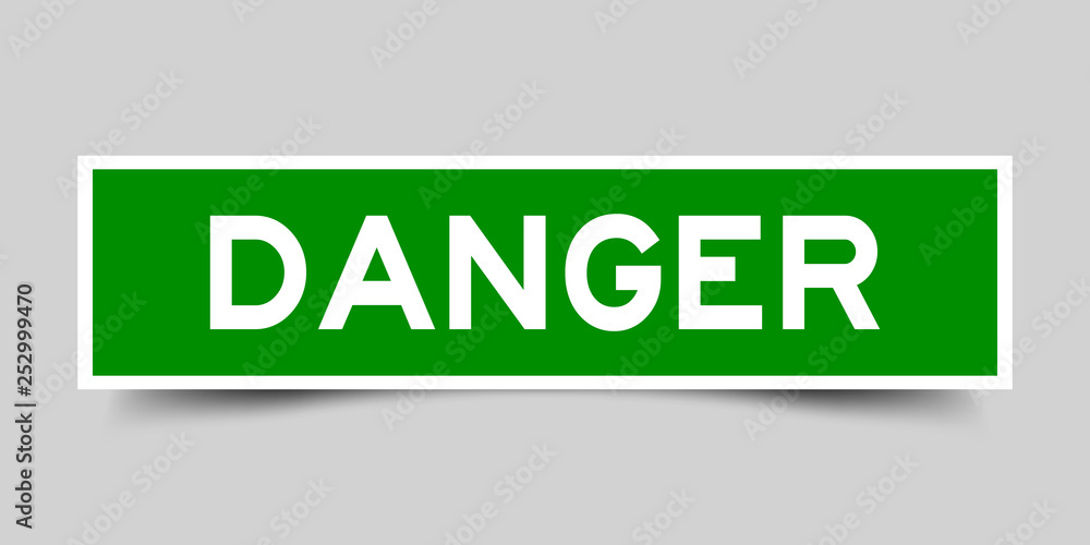 Square green danger sticker label in word on gray background Square green danger sticker label in word on gray background