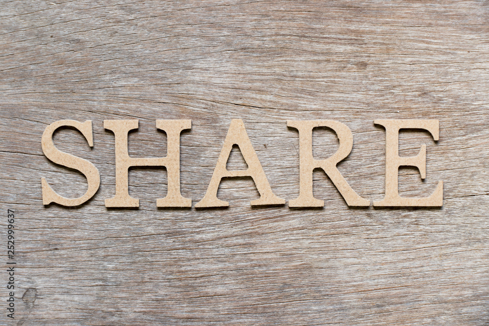 Alphabet letter in word share on wood background Alphabet letter in word share on wood background