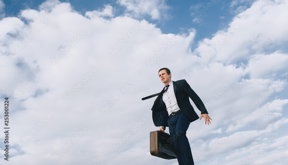 An executive young salesman hurries to do the work. Goes by broad strides. Business concept. An executive young salesman hurries to do the work. Goes by broad strides. Business concept.