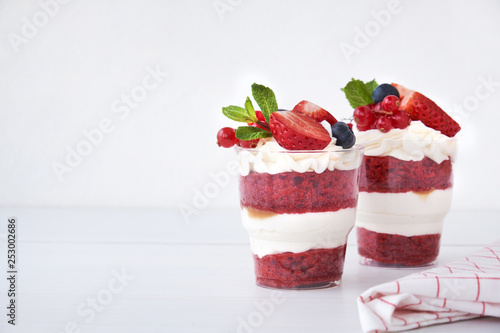 Cake dessert. Trifle red velvet in glass with fresh berry, mint leaves.