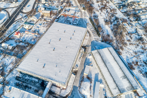 Large warehouse hangar, industrial zone of the city. Sunny winter day.