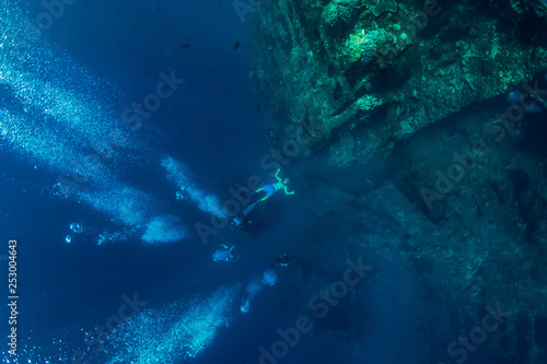 Freediver man make bubbles at underwater shipwreck, Bali © artifirsov