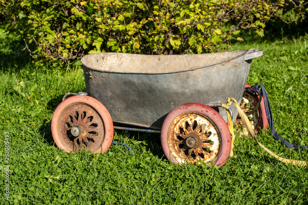 Tin bath on old wheels from baby carriage for work in garden