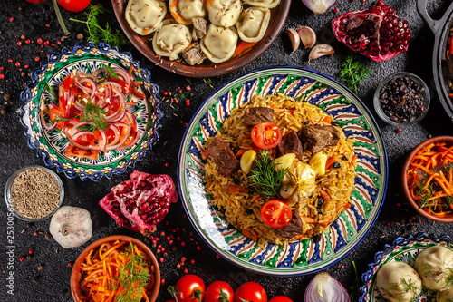 Traditional Uzbek oriental cuisine. Uzbek family table from different dishes in national dishes for the New Year holiday. The background image is a top view, copy space, flat lay