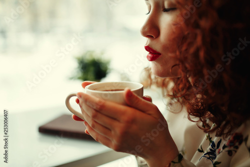 woman in a cafe drinking coffee