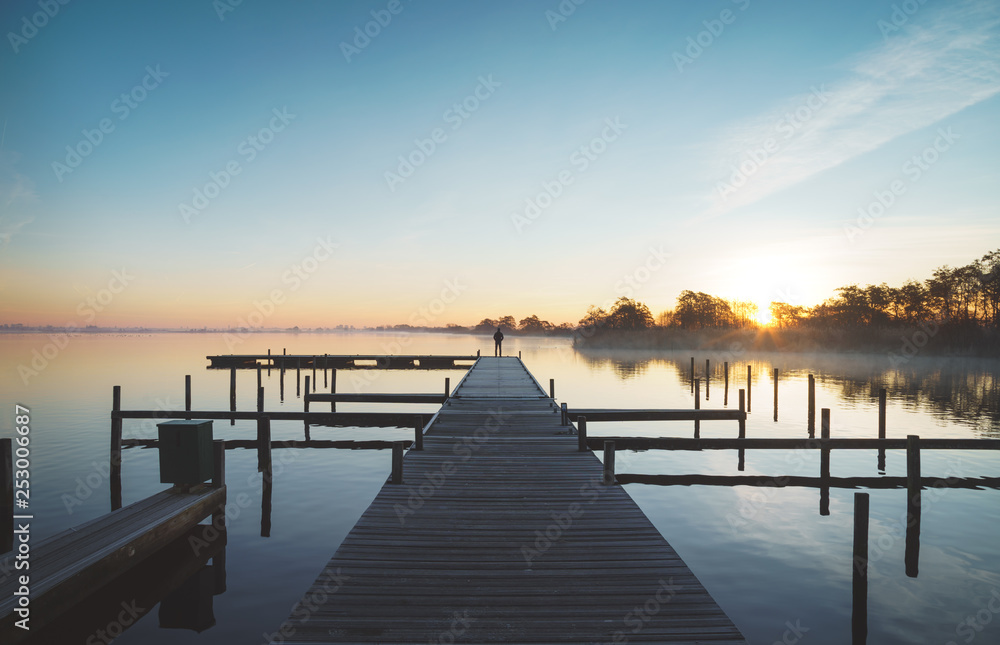 Tranquil dawn at a jetty at the Leekstermeer, in Holland.