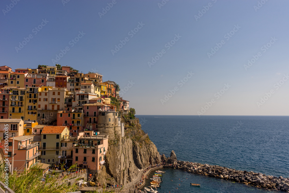Italy, Cinque Terre, Manarola,PANORAMIC VIEW OF SEA AND BUILDINGS AGAINST CLEAR SKY