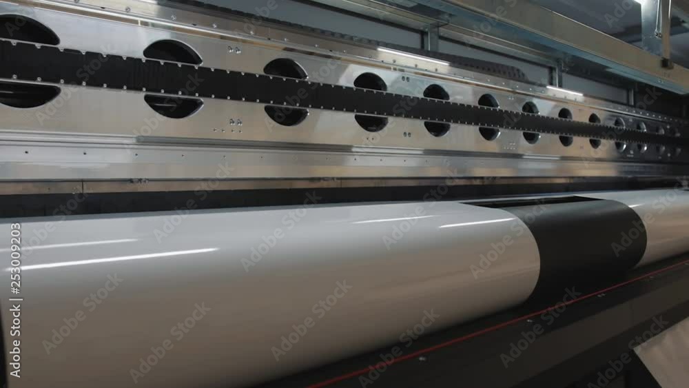 Details of a moving print head. Massive machinery. Professional printing facility, big vinyl rolls, ready for export. Glossy, matte, ecological materials used for commercial billboards and press. Details of a moving print head. Massive machinery. Professional printing facility, big vinyl rolls, ready for export. Glossy, matte, ecological materials used for commercial billboards and press.